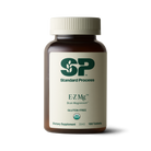 Image of E-Z Mg bottle next to tablets of magnesium supplements.
